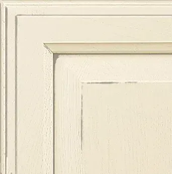 Off-white, close-up of a distressed, framed cabinet door with a recessed panel.