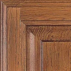 Close-up of a wooden cabinet door in a medium brown finish with detailed grain.