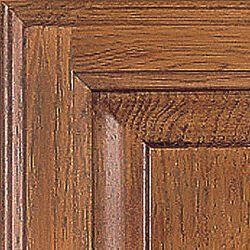 Close-up of wooden cabinet door with raised panel and dark brown finish.