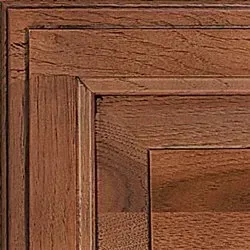 Close-up of a brown, wooden cabinet door with detailed paneling and a natural wood grain texture.