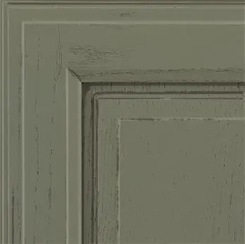 Close-up of a distressed olive green cabinet door corner.