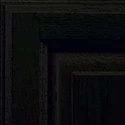 Corner of a dark wood cabinet with panel details, black color, shadows visible.