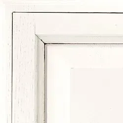Close-up of a white, painted wooden frame with a corner joint.