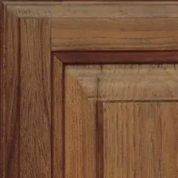 Wooden cabinet door corner with a raised panel.