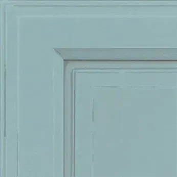 Corner of a light blue cabinet door with raised panels.