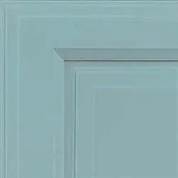 Close-up of a teal cabinet door corner, showcasing recessed panel design.