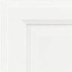 White cabinet door corner with raised panel and molding details.