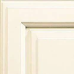 Cream-colored kitchen cabinet detail, showing a raised panel and decorative trim.