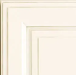 White cabinet door with recessed panel and layered trim.