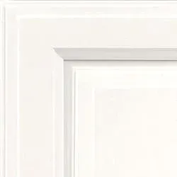 Close-up of a white cabinet door corner with layered, raised panel design.