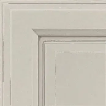Corner of a white, raised-panel cabinet door with a recessed central square, showing details of the paint finish.