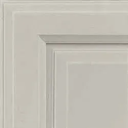 Close-up of a gray cabinet door corner, showing raised panel and layered molding.
