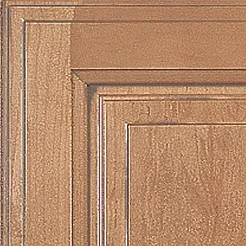 Close-up of a light brown wooden cabinet door with raised panel and layered frame detailing.