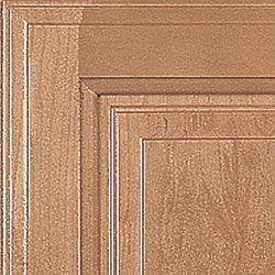 Close-up of a section of a wooden cabinet door in a light brown color, showing raised panel details.