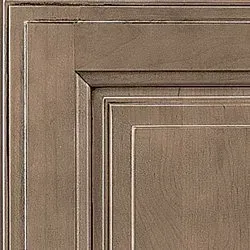 Close-up of a square, framed cabinet door. The wood has a grayish-brown stain and a recessed panel.