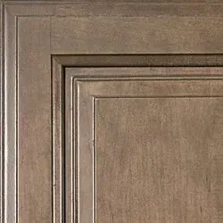 Close-up of a wooden cabinet corner, showing detailed trim and a stained, textured surface.