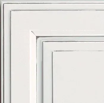 White painted cabinet corner with layered trim.