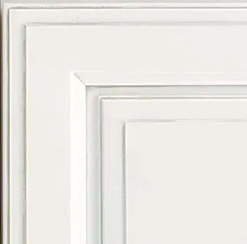 White kitchen cabinet door corner with recessed panels.