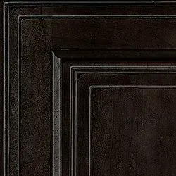 Dark brown wooden cabinet door detail with raised panel design.