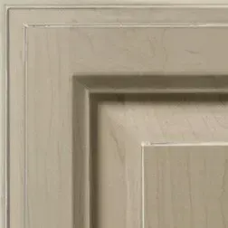 Close-up of a light beige, raised-panel cabinet door with a recessed central panel.
