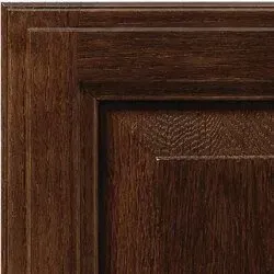 Close-up of a dark wood cabinet door showing the grain pattern.