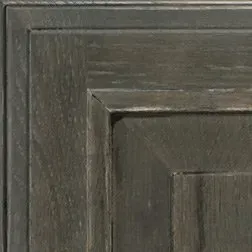 Close-up of a dark gray wooden cabinet door with a recessed panel and layered frame detail.