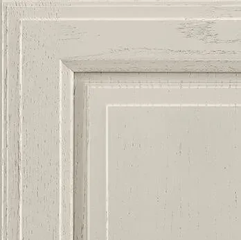 Close-up of off-white cabinet door, featuring layered panels with a textured, distressed finish.