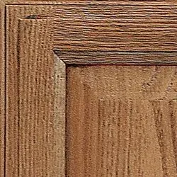 Close-up of a wooden cabinet door with visible grain and a dark brown finish.