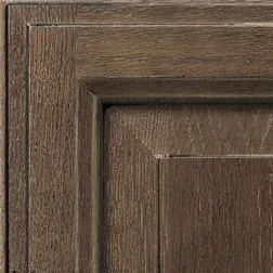 Close-up of a textured, dark brown wood panel with a raised, squared frame.