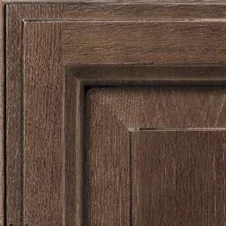 Close-up of a textured, dark brown wooden cabinet door detail.