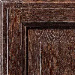 Close-up of dark stained wood paneling, showing intricate grain and trim detail.