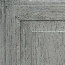 Close-up of a weathered gray wooden cabinet door showing grain details.
