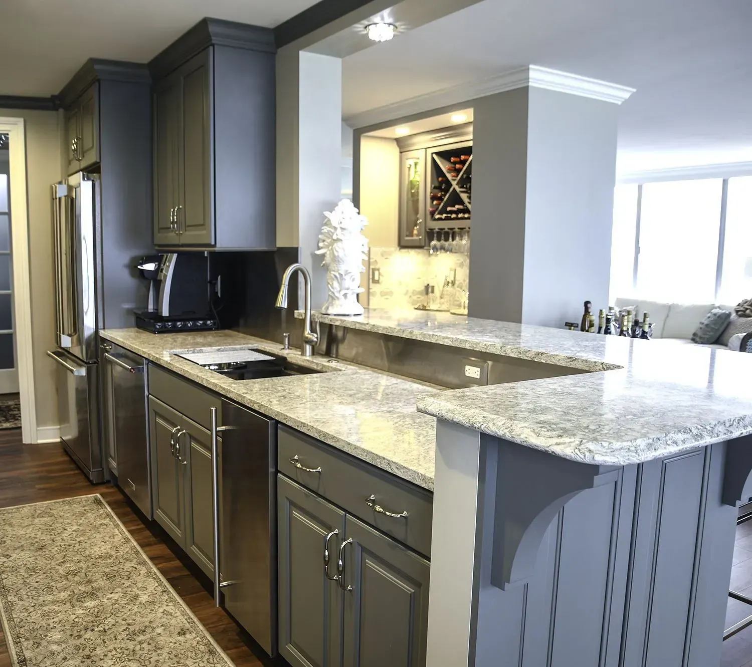 Gray kitchen with stainless steel appliances and granite countertops.