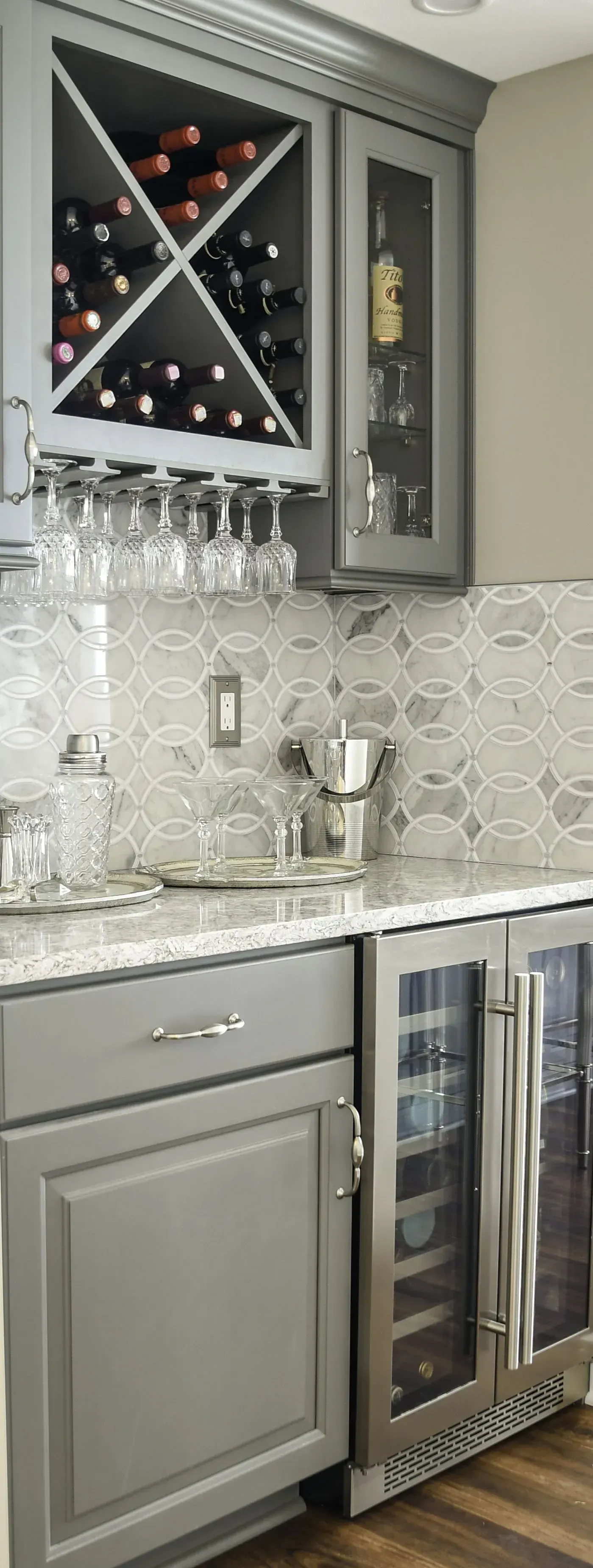 Gray bar area with wine storage, cabinets, and a wine refrigerator.