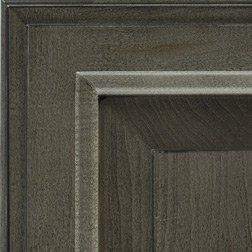 Close-up of a gray-stained wooden cabinet door with raised panel detailing.