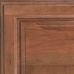 Close-up of a wooden cabinet door, showing the grain and details of the wood finish.