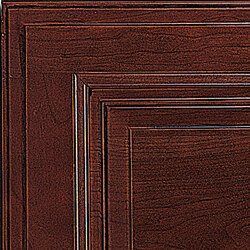 Close-up of a dark cherry wood cabinet door with panel detailing.