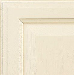 Cream-colored cabinet door corner with raised panel and detailed molding.