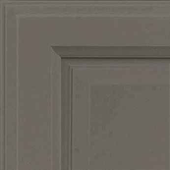 Close-up of a gray cabinet door corner with raised panel and molding detail.