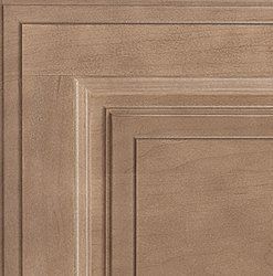 Close-up of a brown wooden cabinet door with layered, textured panels and trim.