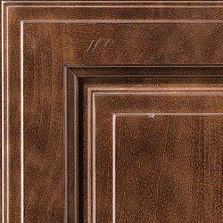 Close-up of a brown, wood-grain cabinet door with layered, framed panels.
