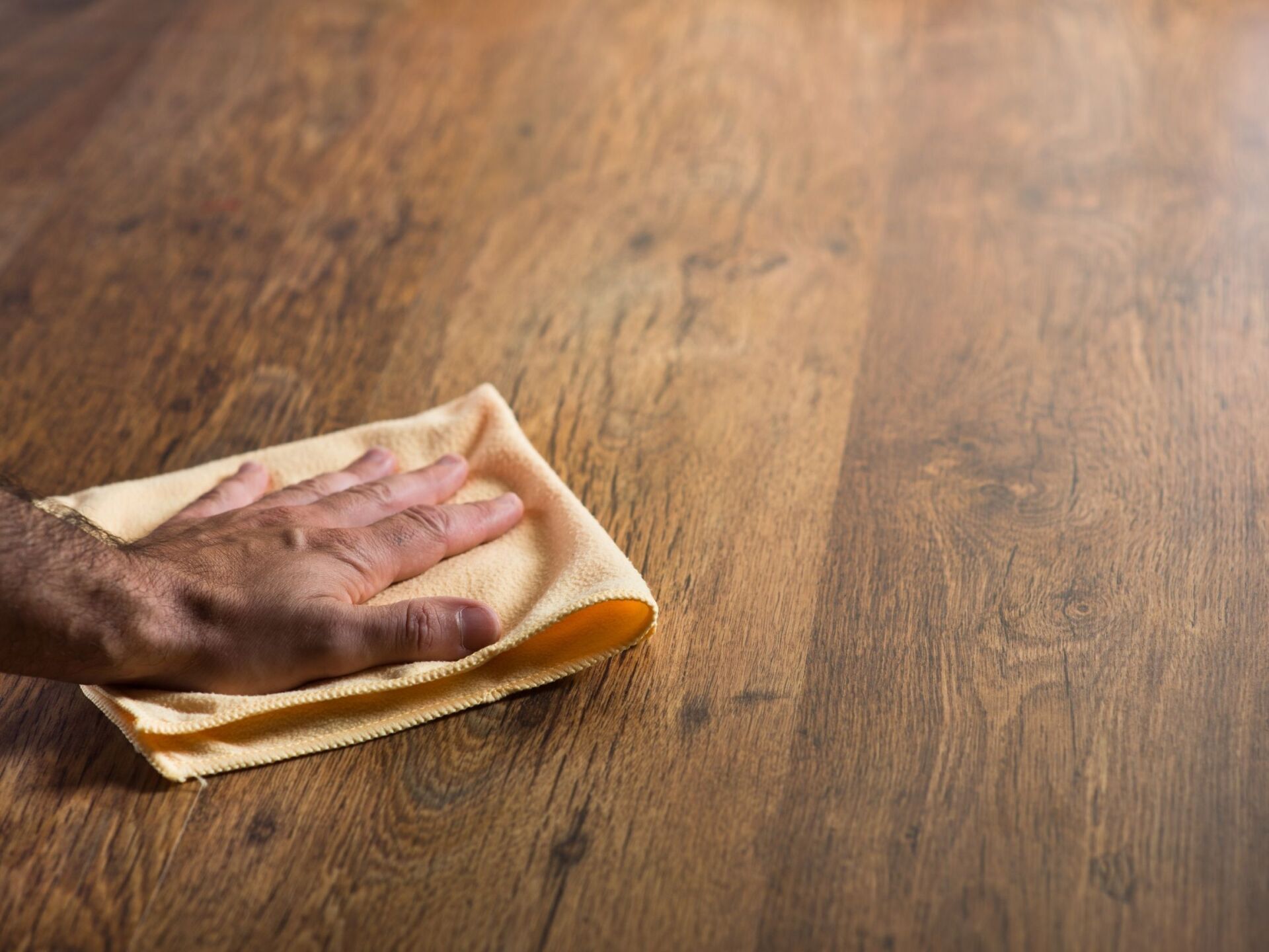 new installation of hardwood floor being wiped down with a cloth in Nova Scotia