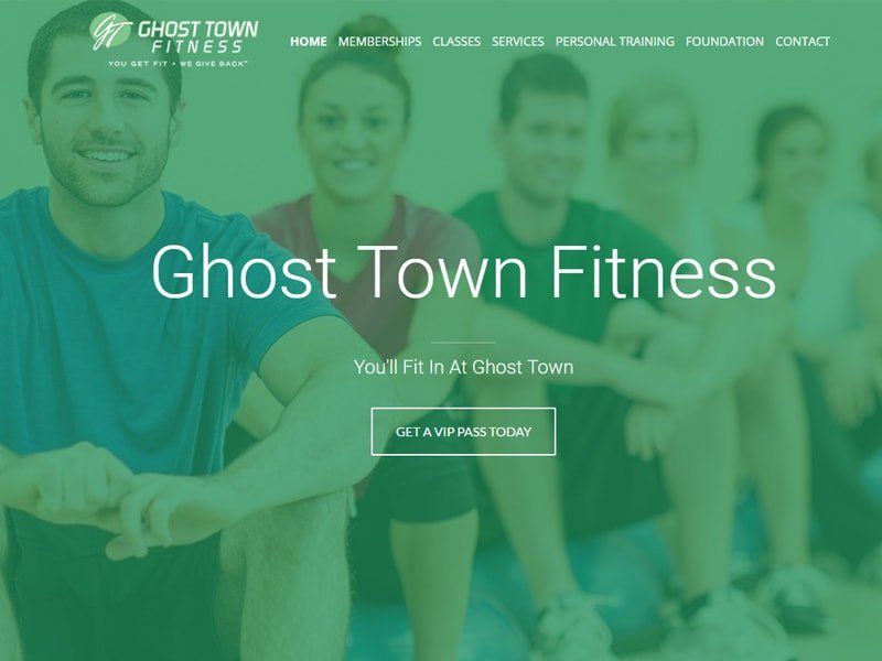 Ghost Town Fitness website homepage with group of smiling people in fitness wear.