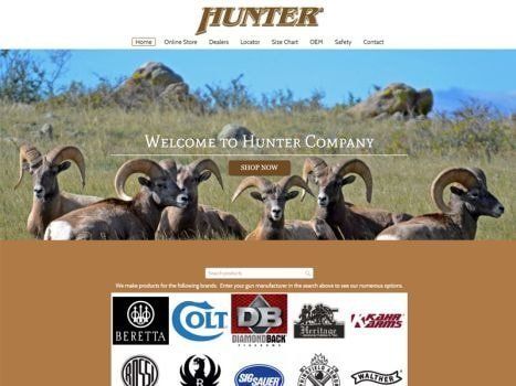 Hunter Company website featuring a group of bighorn sheep. Logos of gun brands are displayed below.