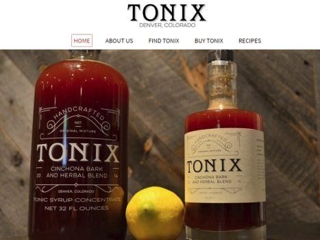 Two bottles of Tonix tonic syrup with a lemon. Website header at the top.