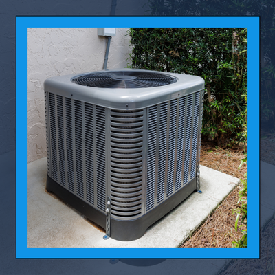 An air conditioner is sitting on the side of a building