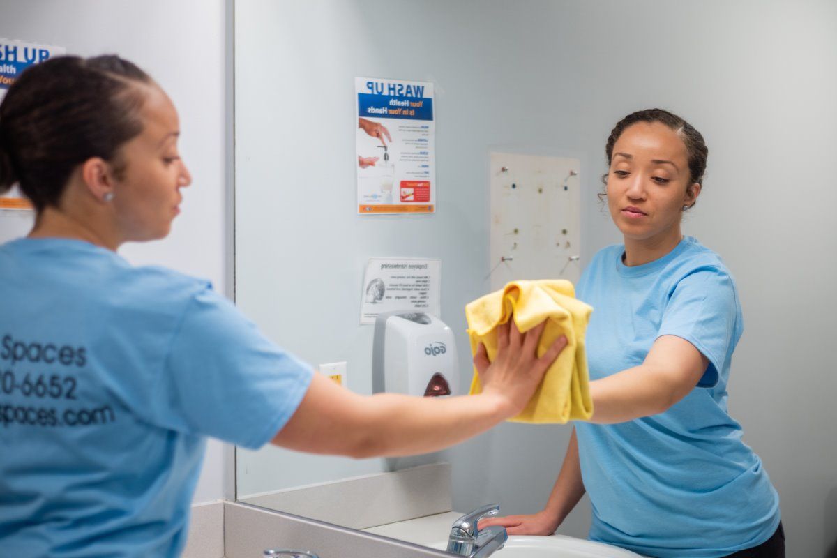 Woman cleaning a commercial bathroom