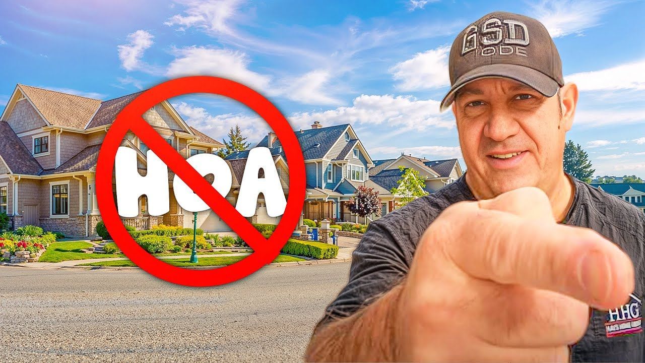 Man pointing, houses in background,