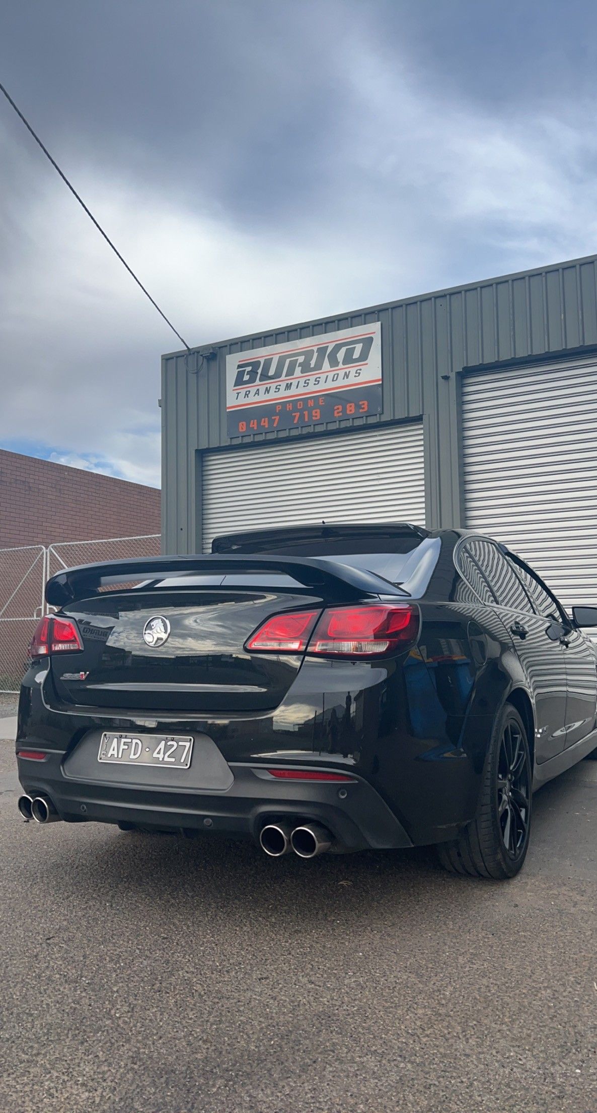 A black car infront of workshop — Burko Transmissions in Shepparton, VIC