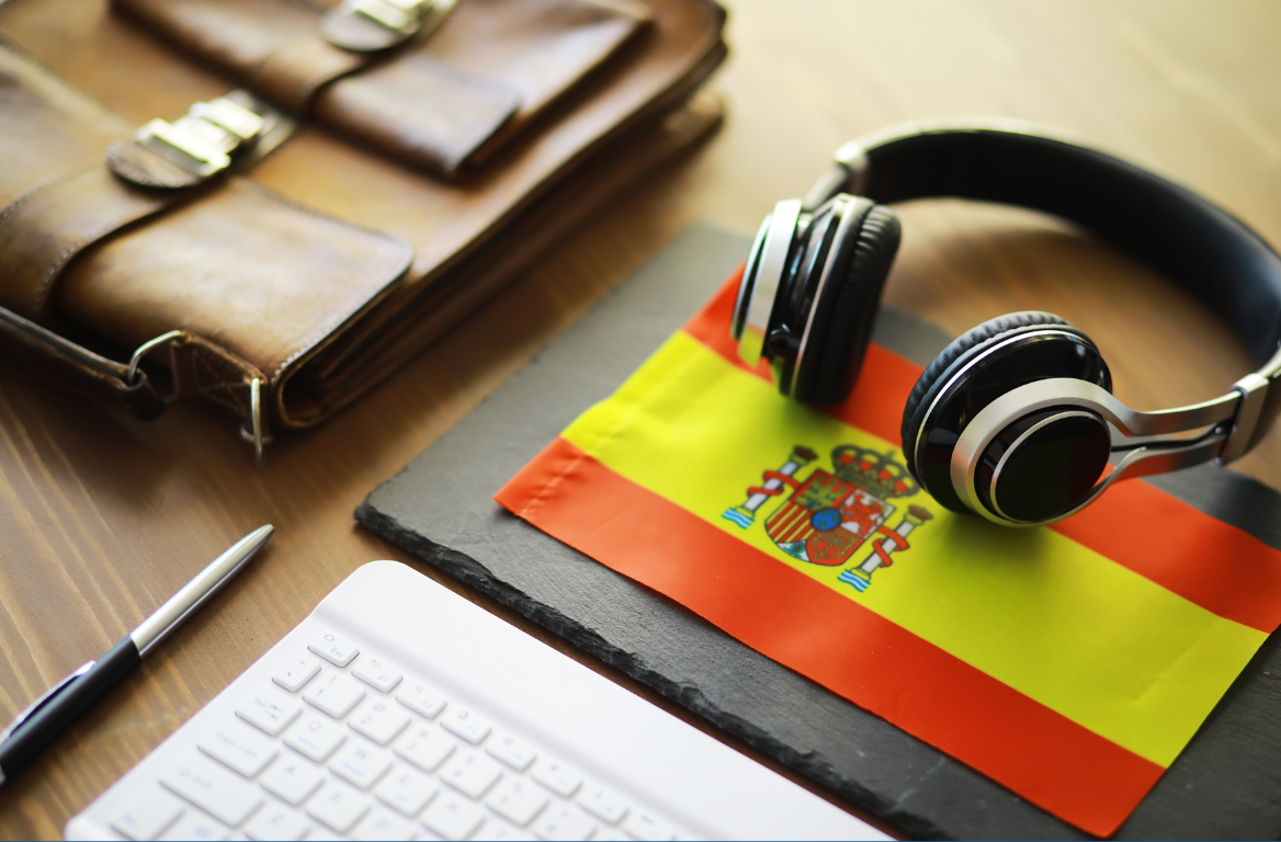 A pair of headphones sitting on top of a spanish flag